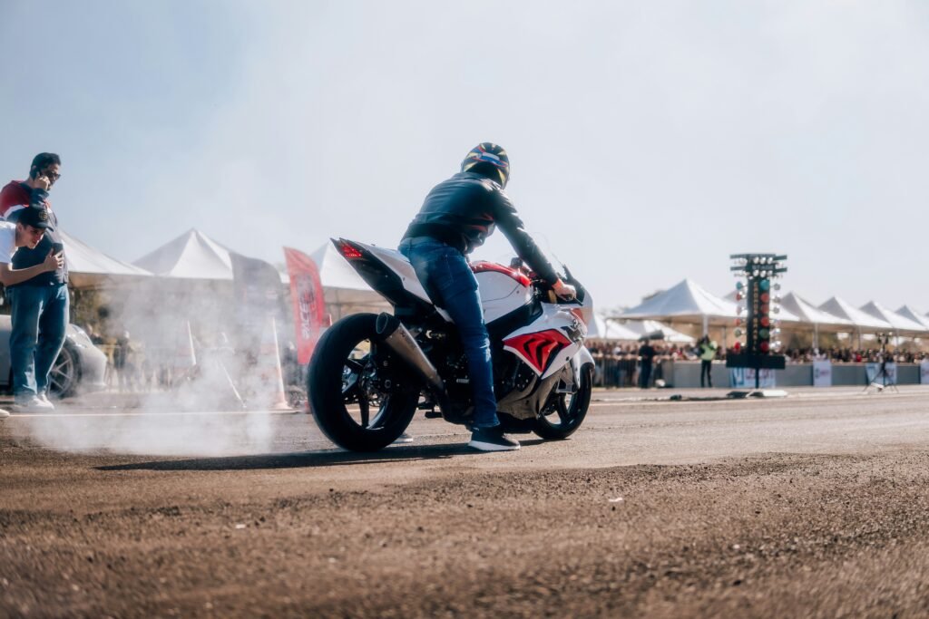 a man riding a motorcycle on top of a dirt road